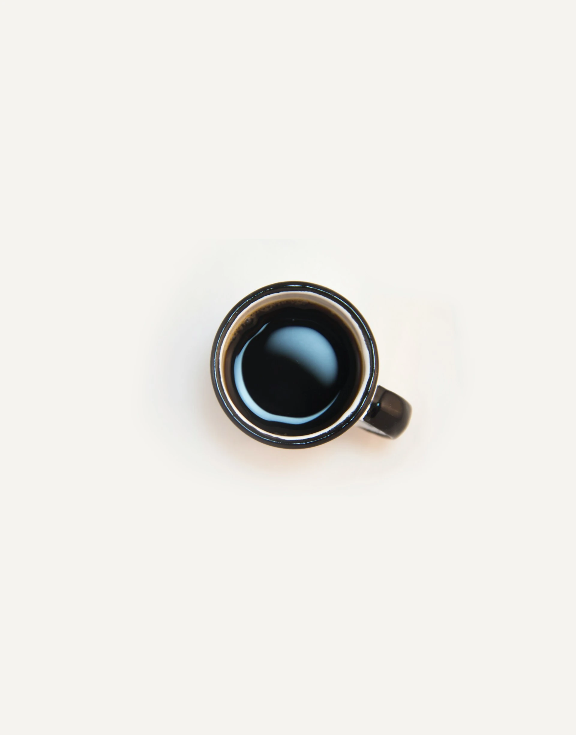A cup of black coffee seen from above
